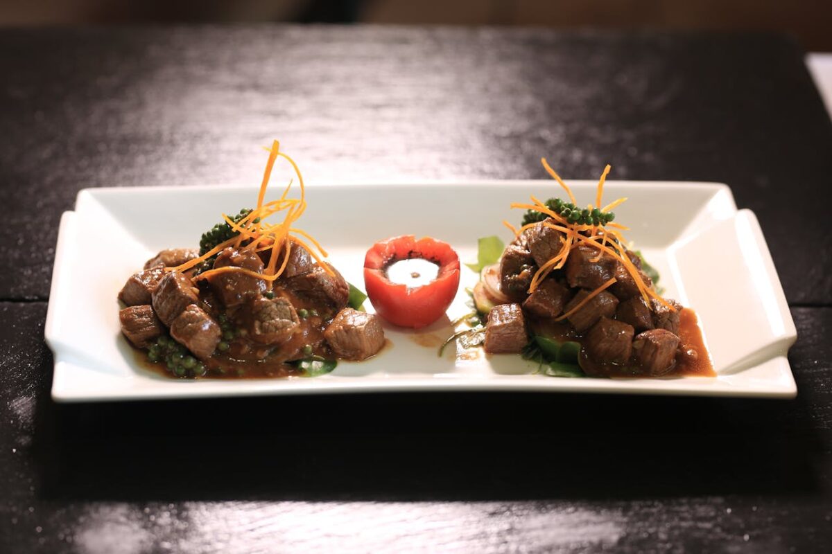 A beautifully presented beef dish in Phnom Penh, Cambodia, garnished with vegetables.